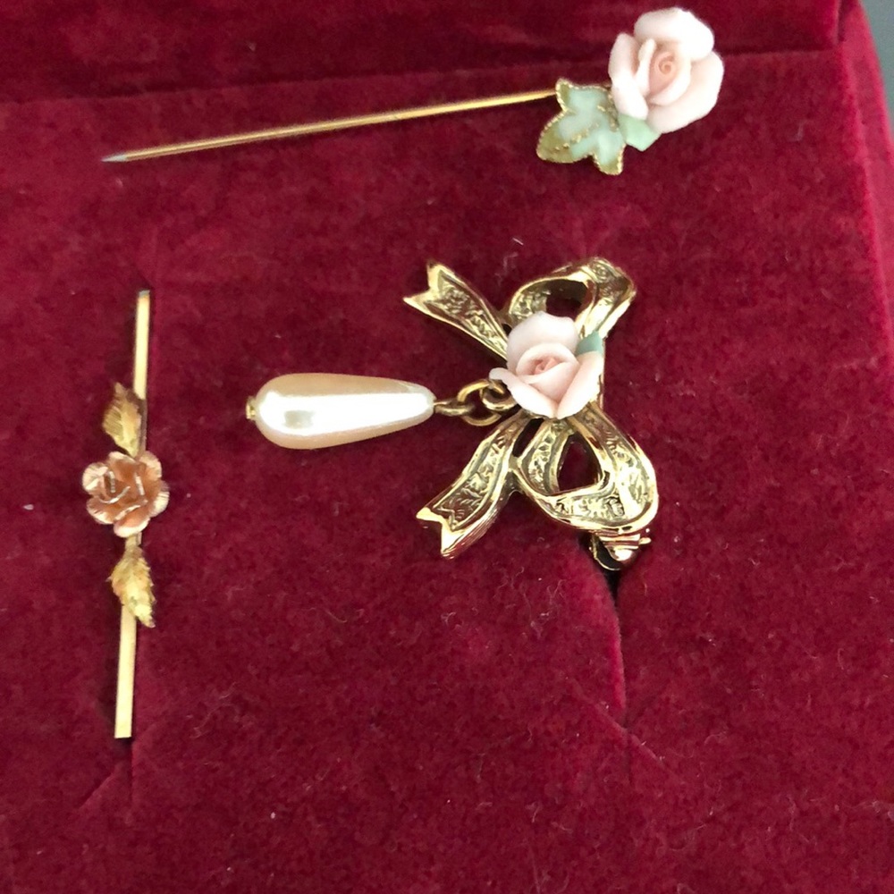 Three gold tone vintage rose pins including two brooches and one ceramic hat pin